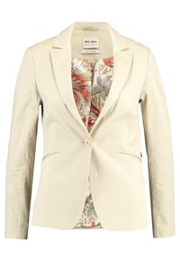 Blazer beige sur mesure à manches longues, deux poches avant, fermeture à un bouton, et doublure à motifs floraux aux couleurs vives.