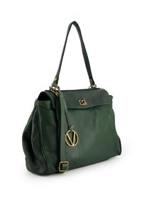 Green leather handbag with a structured shape, gold hardware, and a decorative circular accent. Features short straps and a textured flap.