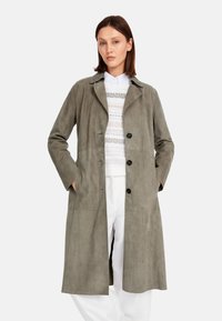 Gray, suede-like long coat with a notched collar, front button closure, side pockets, and smooth texture. Worn over a light, patterned sweater.