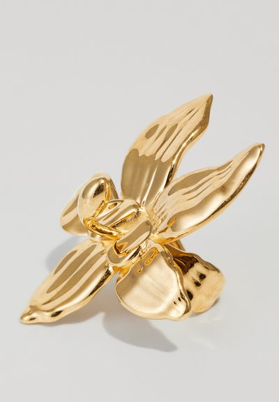 Bague florale dorée avec un design de fleur texturé et poli, comprenant quatre pétales et un centre sphérique. La surface réfléchissante accentue l'éclat.