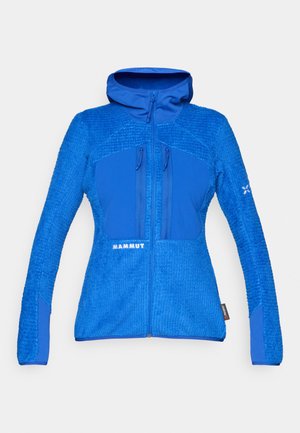 Blaue Jacke aus einem strukturierten, fleeceartigen Material mit glatten Einsätzen. Mit Kapuze, Reißverschluss und zwei Reißverschlusstaschen auf der Brust.