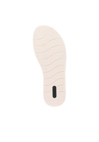 Suola di scarpa di un beige chiaro con superficie texture, caratterizzata da scanalature pronunciate per una migliore aderenza e un elemento logo nero al centro.