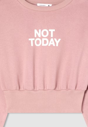 Felpa corta rosa con polsini e orlo a coste. La parte anteriore presenta un testo bianco che recita "NON OGGI." Morbido tessuto.