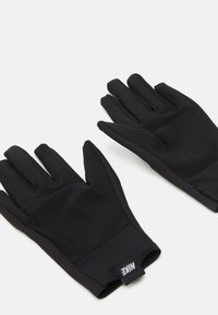 Black Nike gloves with a smooth surface and textured accents on fingers. Made from flexible material, designed for grip and comfort.