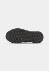 Rubber sneaker sole featuring a textured black surface with a diamond-pattern tread for grip and traction, rounded edges, and defined contours.
