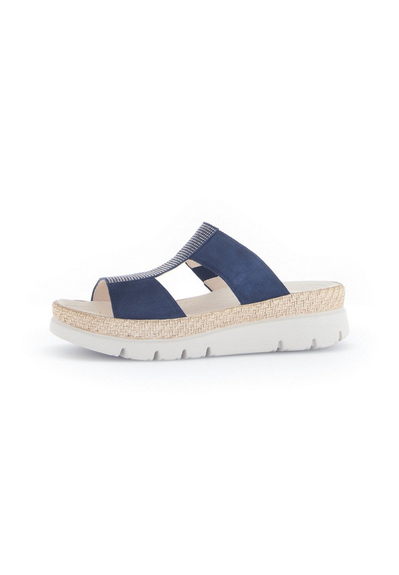 Navy blue suede sandals with a woven, beige platform sole. Open toe design features cut-out sections and elastic accents for flexibility.