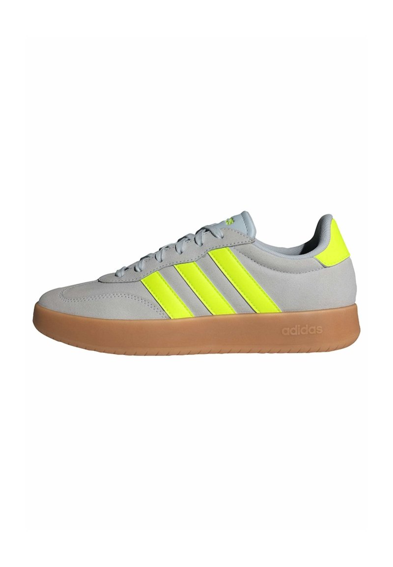 Gray suede athletic shoe with bright yellow accents and three stripes. Features a gum rubber outsole and padded collar for comfort.