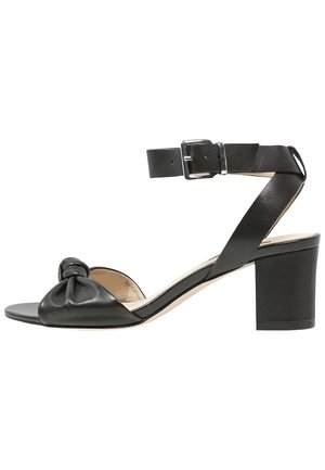 Černá kožená sandála s otevřenou špičkou, blokovým podpatkem, uzlovým předním páskem a nastavitelným kotníkovým páskem se stříbrnou přezkou.
