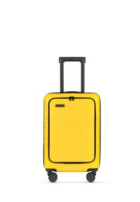 Yellow hard-shell suitcase with a black retractable handle, four wheels, ribbed texture, and a zipper closure.