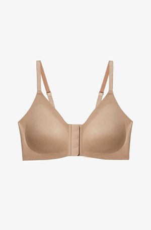 Nude bra with smooth, padded cups, adjustable straps, and a front closure featuring six hook-and-eye clasps. Soft, stretchy fabric texture.