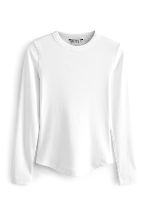 T-shirt blanc à manches longues, à col rond côtelé, avec un ourlet arrondi et des fentes latérales, fabriqué dans un tissu doux et texturé.