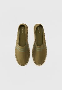 Green canvas espadrilles with brown woven sole. Features blue stripes across the upper. Slip-on design with padded interior.