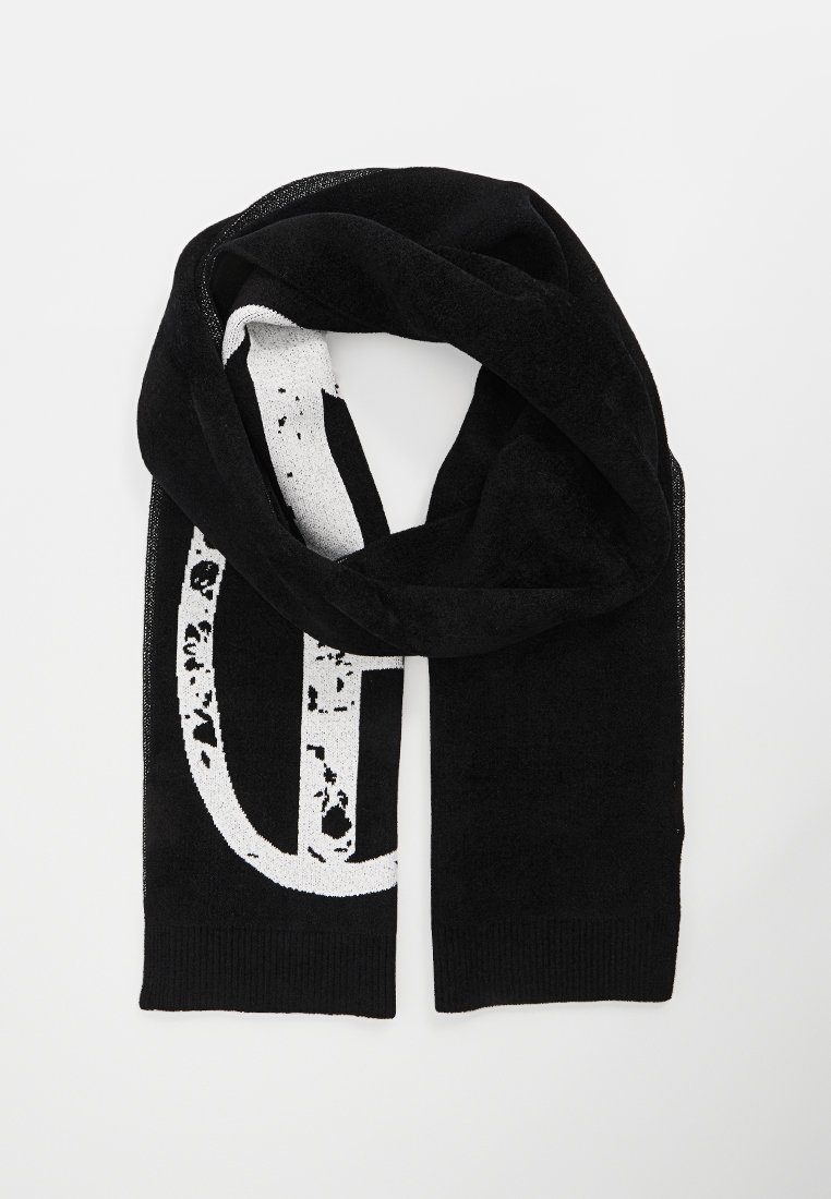 Black knit scarf featuring a large white graphic print with a distressed texture. Soft material with a ribbed edge at both ends.