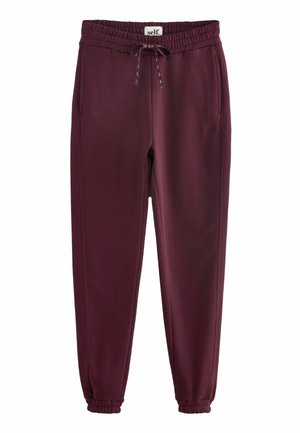 Pantaloni sportivi bordeaux realizzati in tessuto morbido, con vita elastica, cordino e polsini alla caviglia. Due tasche laterali visibili.
