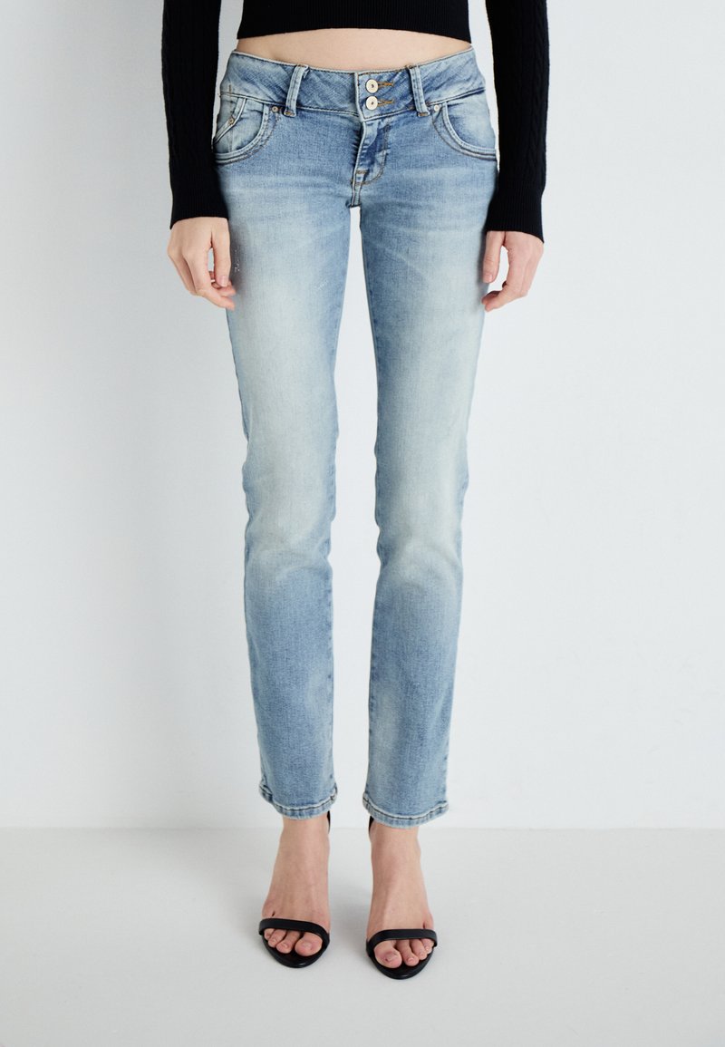 Light blue denim jeans with a slim cut, five-pocket design, and a button-up closure. Features a faded finish and cropped hem.