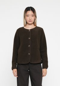 Dark brown fleece jacket with a round neckline, five button closure, and long sleeves. Features soft texture and contrasting trim.