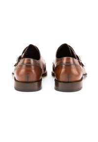 Brown leather shoes featuring a sleek design, rounded toes, and a low heel. Notable buckle detail and smooth texture on the surface.