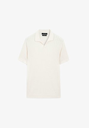 Kortærmet polo skjorte i cremefarve med ribbet tekstur og flad krave. Har en lige kant og blødt materiale for komfort.