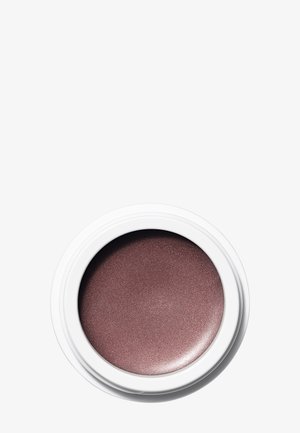 Contenant blanc circulaire contenant une ombre à paupières mauve scintillante sur un fond blanc uni.