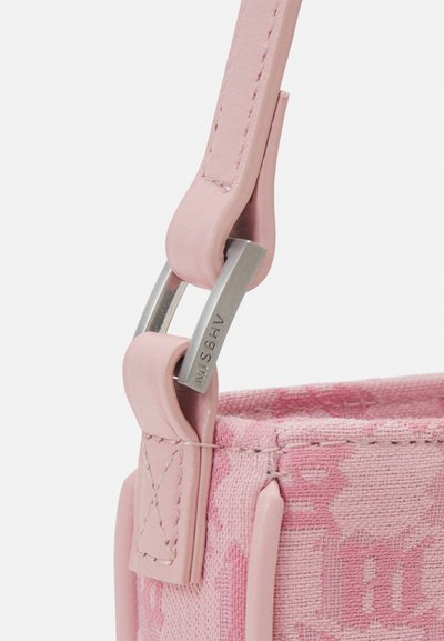 Pink fabric bag with leather accents. Features silver hardware, stitched edges, and a textured pattern on the surface.