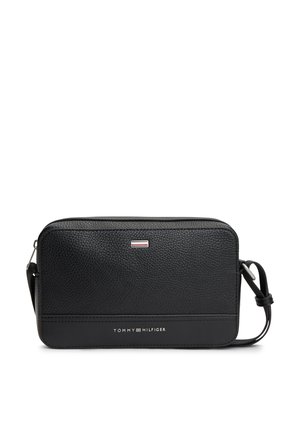 Black textured leather Tommy Hilfiger crossbody bag with adjustable strap and logo on front.
