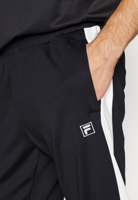 Fila REMOND TRACK PANTS - Calças de fato de treino - black/bright white