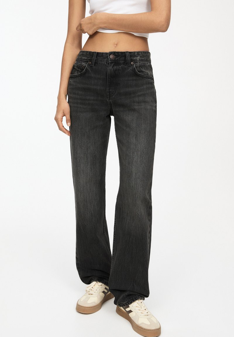 Zwarte rechte jeans met hoge taille, voorzien van subtiele vervaging en een klassieke vijf-pocket stijl, gemaakt van denim.