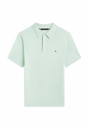 Lichtgroen polo met korte mouwen, drie knopen en een klein geborduurd Tommy Hilfiger-logo op de linkerborst.