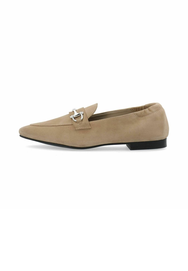 Beige suede loafers with a pointed toe and silver hardware accent. Features a flat black sole and elasticized collar for a snug fit.