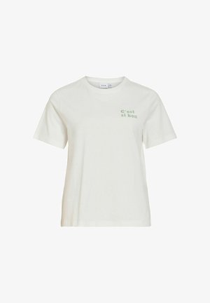 Fehér, rövid ujjú, kerek nyakú póló, ami bal felső mellrészen kis zöld „C'est si bon“ felirattal rendelkezik.