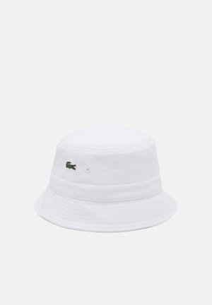 White cotton bucket hat featuring a textured finish, with a green embroidered crocodile logo on the side and a slightly curved brim.