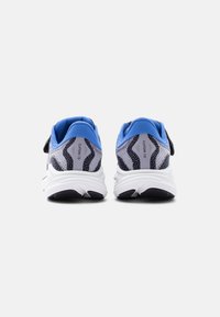 Ζευγάρι γκρι, μαύρα και μπλε αθλητικά παπούτσια για τρέξιμο με λευκές σόλες, εμφανιζόμενα από πίσω σε απλό λευκό φόντο.