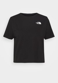 Černé krátké rukávy crop tričko vyrobené z měkké bavlny, s malým bílým logem na levé části hrudi. Jednoduchý design, bez dalších vzorů.