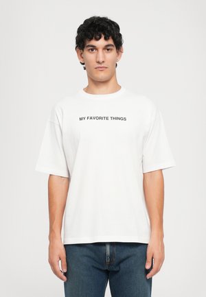 White cotton t-shirt with short sleeves, featuring the text "MY FAVORITE THINGS" in bold black letters across the chest.