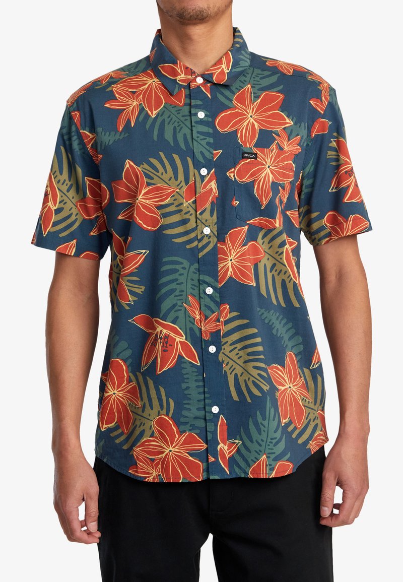 Short-sleeve button-up shirt with a navy background, featuring large red flowers and green foliage patterns. Cotton material with chest pocket.