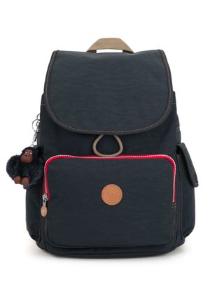 Navy blue backpack with a textured fabric, brown leather accents, red zipper detail, and a plush monkey keychain attached.