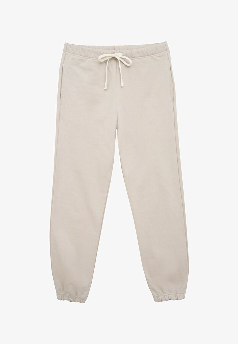 Beżowe spodnie dresowe z elastycznym pasem i regulowanym sznurkiem. Posiadają dwie boczne kieszenie oraz zwężane mankiety na kostkach. Miękka tekstura.