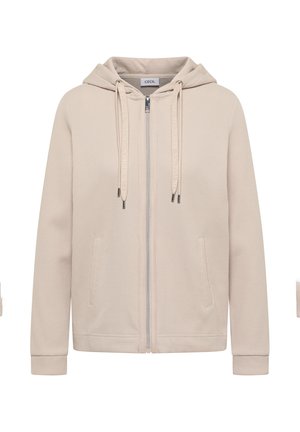 Sweat à capuche beige avec fermeture éclair, tissu texturé, poches avant, cordons avec embouts métalliques, et une étiquette cousue à l'intérieur du col portant l'inscription "Cecil".