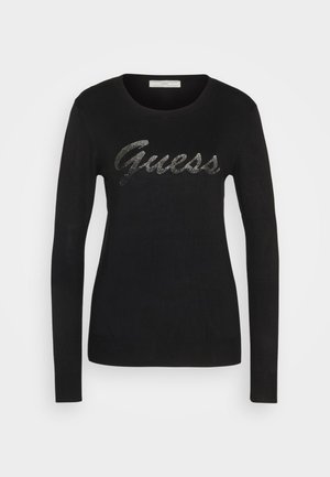 Čierny pletený sveter s dlhými rukávmi, predná strana obsahuje kovový logo "Guess", okrúhly výstrih a rebrované manžety a lem.