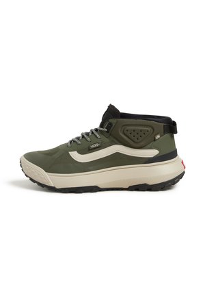 Green hiking shoes with a high-top design, featuring a beige midsole, black accents, grey laces, and a textured outsole for grip.