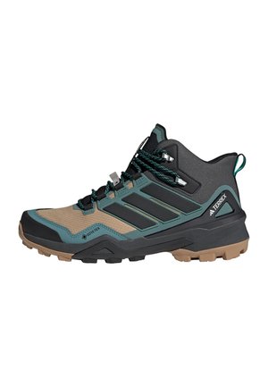 Scarponi da trekking realizzati con una combinazione di materiali neri, verde acqua e beige, dotati di una parte superiore testurizzata, lacci sicuri e suola in gomma robusta per una buona aderenza.