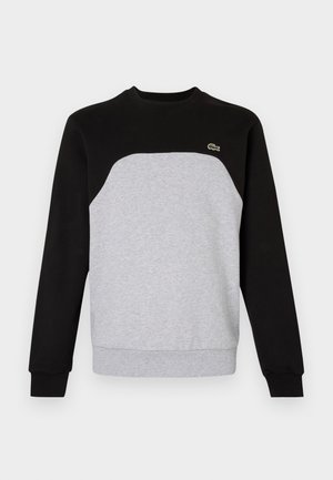 Grijze en zwarte sweatshirt met een ronde hals, lange mouwen en ribgebreide manchetten. Bevat een contrasterend paneelontwerp en een klein logo.