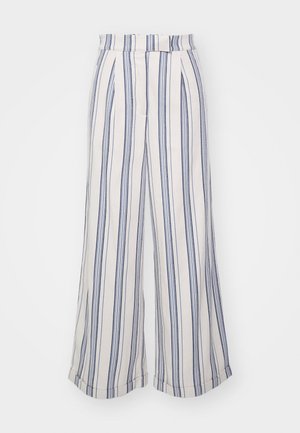 Črtaste široke hlače v kremni in mornarsko modri barvi, narejene iz mehkega blaga. Imajo prilegajoč se pas in zavihane robove, ki poudarjajo vertikalne črte.