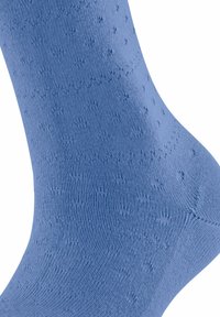 Calzino in cotone blu con un motivo testurizzato di piccole punte rialzate, con dettagli a coste sulla caviglia e una finitura liscia.