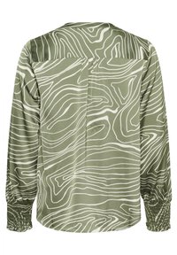 Blusa verde con un motivo a righe ondulate bianche, maniche lunghe con polsini arricciati e una vestibilità rilassata con una piega sul retro per il movimento.