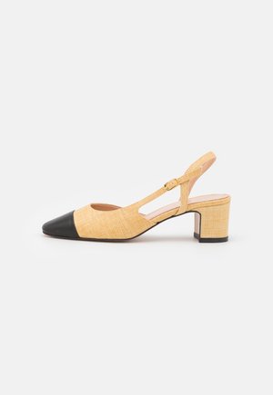 Slingback shoe with a textured yellow upper and a black pointed toe. Features a block heel and a gold buckle on a strap.