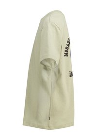 Camiseta de algodón verde claro con mangas cortas, que presenta texto negro en el costado y un escote redondo. Textura suave, ajuste casual.