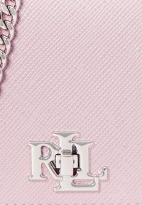 Pink textured leather bag featuring a silver L and R logo hardware detail and a chain strap. Small and compact design.