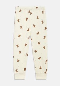 Pantaloni del pigiama in cotone color crema con stampa di orsetti, dotati di vita elastica e polsini a costine alle caviglie.