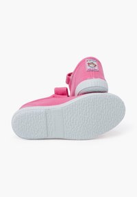 Pink canvas shoes with white soles, Velcro strap, rounded toe, and textured rubber outsole. Tag reads "Made in Spain."